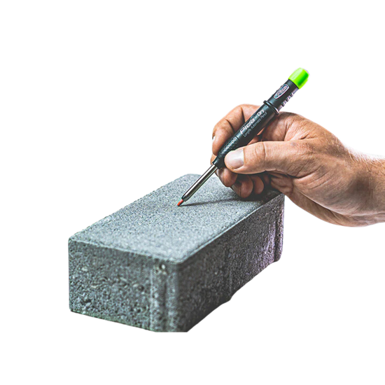Pica-Dry Longlife Automatic Pen in hand marking rough brick; Power Lock grips graphite lead for precision on wet/dusty sur...