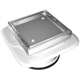 Square stainless steel shower drain with perforated grate on white mounting base