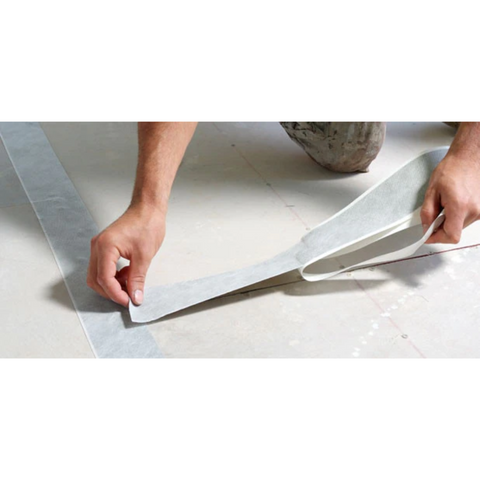 Worker applying Gripset BRW PF butyl rubber waterproofing tape to seal concrete wall-floor junction, compatible with membr...