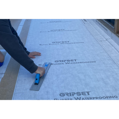 Installer cutting Gripset BRW PFN self-adhesive butyl rubber waterproofing membrane for wet-area floors and balconies, ant...