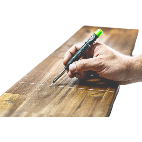 Hand holds Pica-Dry Longlife Automatic Pen marking precise line on timber – dust/moisture-proof for trade prep.